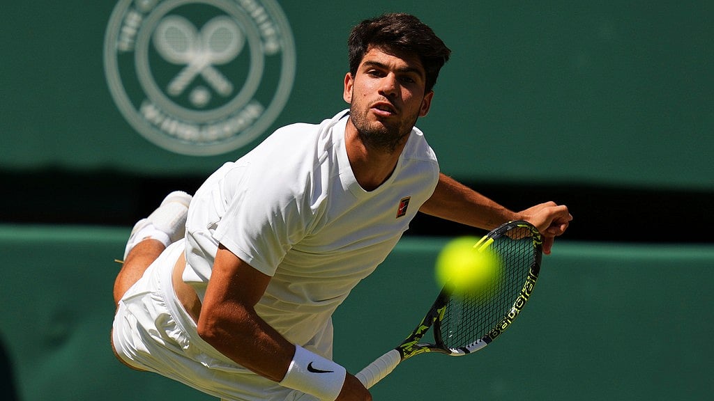 Photo: AP : Carlos Alcaraz Vs Taylor Fritz Highlights, Wimbledon 2025 Semi-Final: Spaniard serves in the first set.
