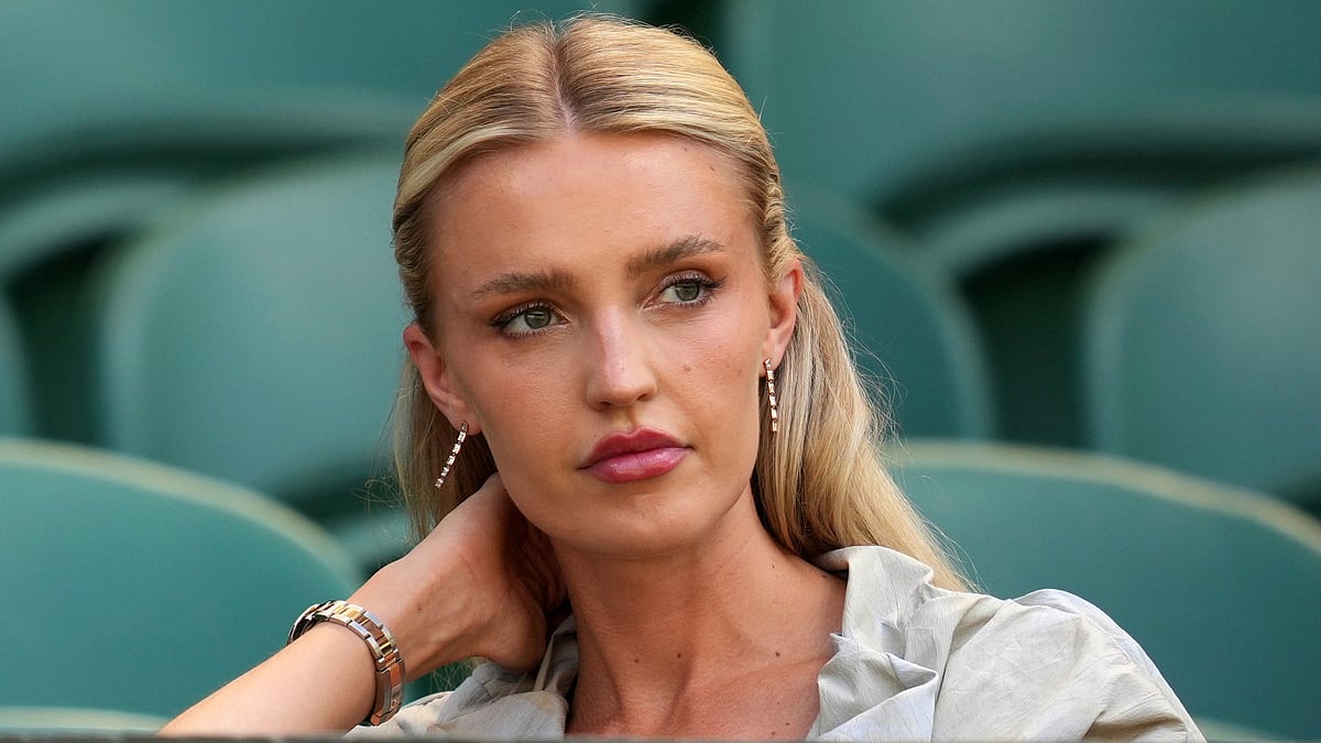 (AP Photo/Kin Cheung) : Morgan Riddle the girlfriend of Taylor Fritz of the U.S. takes her seat before her boyfriend plays Spain's Carlos Alcaraz in a men's singles semifinal at the Wimbledon Tennis Championships in London, Friday, July 11, 2025. 