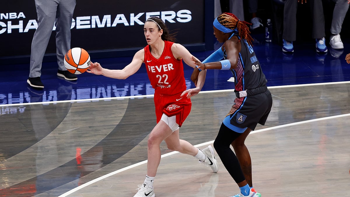 Indiana Fever guard Caitlin Clark (22) makes a pass while defended by Atlanta Dream guard Rhyne Howard (10) in the first quarter of play during a WNBA game between the Atlanta Dream and the Indiana Fever on July 11, 2025, at Gainbridge Fieldhouse in Indianapolis, IN.