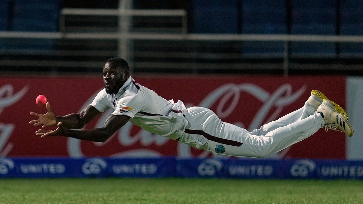 AP Photo/Ricardo Mazalan : West Indies' Anderson Phillip takes the catch to dismiss Australia's Travis Head on day one of the third Test cricket match at Sabina Park in Kingston, Jamaica.