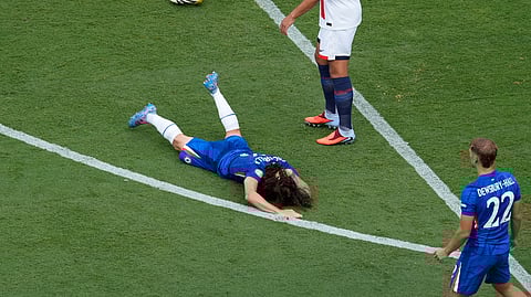 Chelsea's Marc Cucurella, center, grimaces in pain during the Club World Cup final soccer match between Chelsea and PSG in East Rutherford, N.J., Sunday, July 13, 2025.