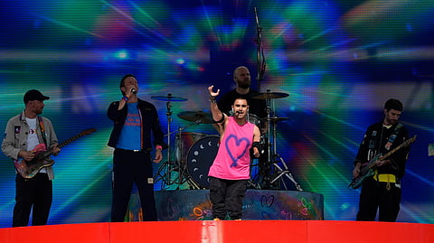 Australian singer Emmanuel Kelly, center, performs at the half time during the Club World Cup final soccer match between Chelsea and PSG in East Rutherford, N.J., Sunday, July 13, 2025.