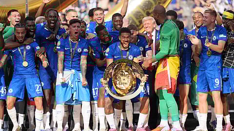 Chelsea's Reece James (24) prepares to lifts the trophy as President Donald Trump looks on following the Club World Cup final soccer match between Chelsea and PSG in East Rutherford, N.J., Sunday, July 13, 2025.