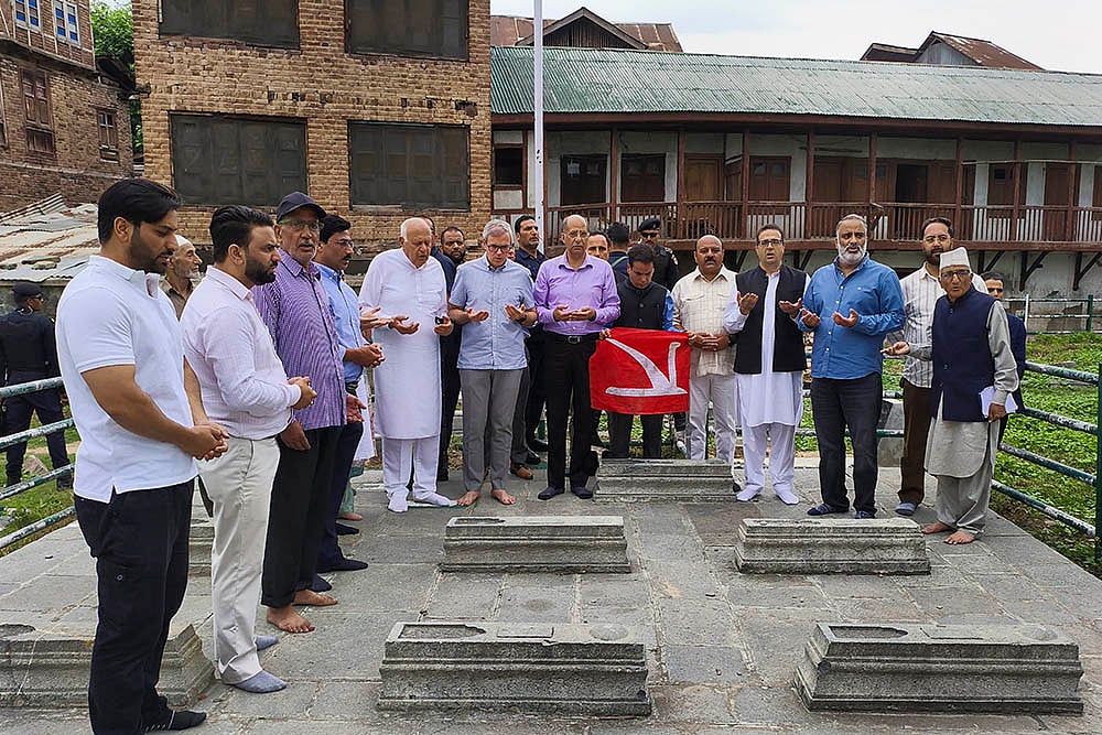 | Photo: PTI/S Irfan : Omar and NC leaders slip through barricades, offer tributes to martyrs in Srinagar