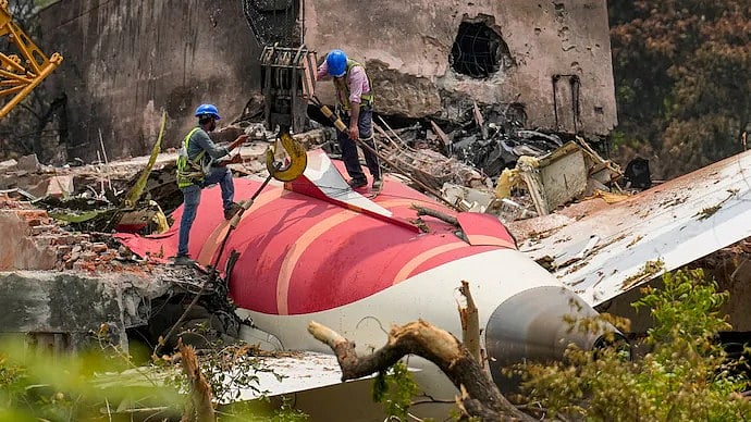 PTI : Rescue workers at the plane crash site in Ahmedabad