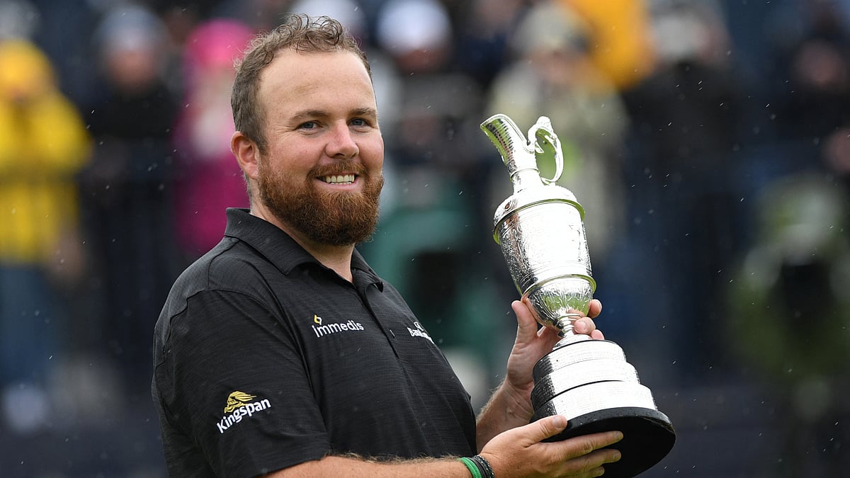 Shane Lowry poses with the Claret Jug in 2019