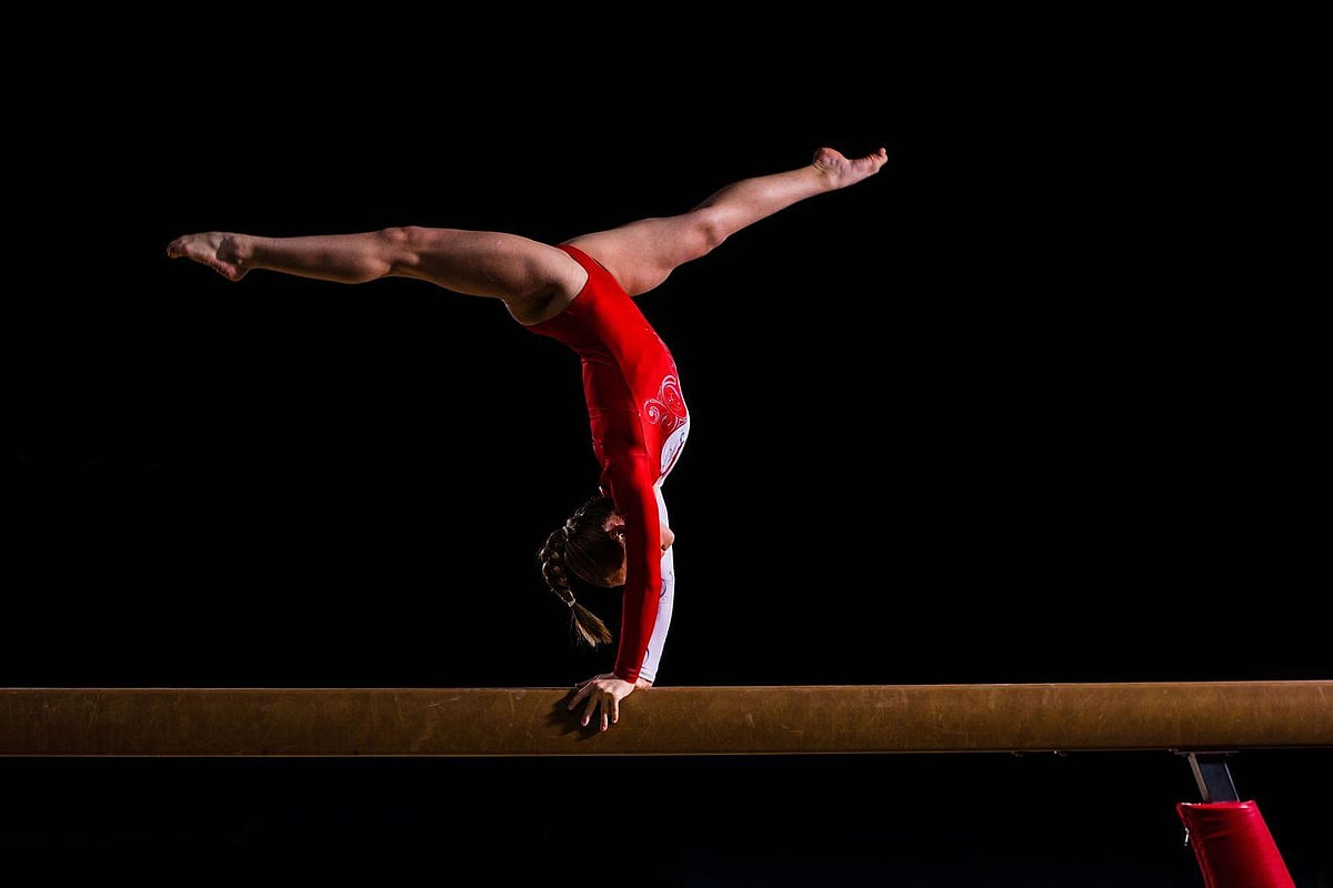 Gymnast posing on balance beam