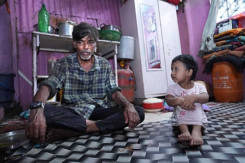 Ramesh Moti Parmar, 56, sits on the tiled floor of his one-room home in Kamla Nagar, Dharavi, beside his granddaughter. Ramesh is an informal sanitation worker no gloves, no ID, no dignity. Every day, he descends into Mumbai’s manholes, armed with only a rod and a prayer.