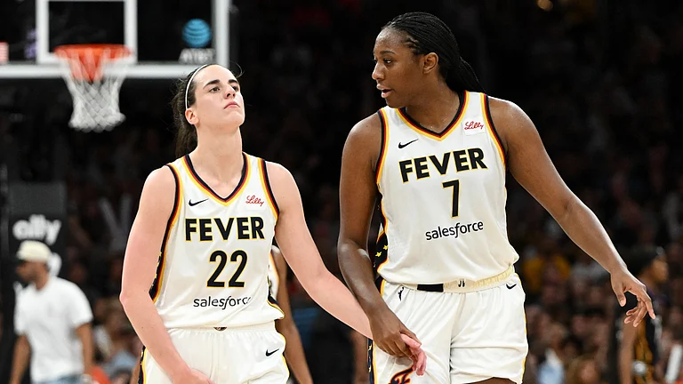 Aliyah Boston #7 helps Caitlin Clark #22 of the Indiana Fever walks to the bench after being taken out of the game with an injury during the second half of a game against the Connecticut Sun at the TD Garden on July 15, 2025 in Boston, Massachusetts. - null