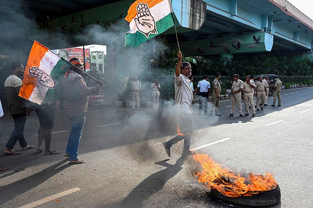 | Photo: PTI : Odisha Bandh: Congress workers block a road in Bhubaneswar