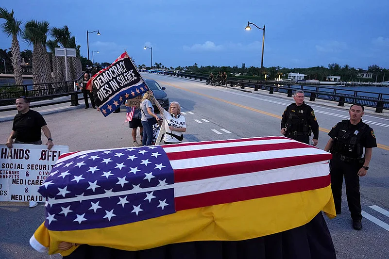 Good Trouble Protests Against Trump Being Held Across United States_flag-draped coffin