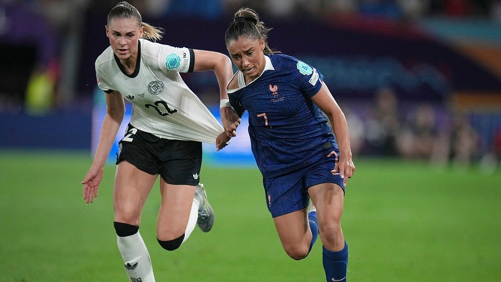 AP : Germany's Jule Brand, left, fights for the ball with France's Sakina Karchaoui during the Women's Euro 2025 quarterfinals soccer match.