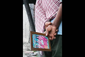 | Photo: Tribhuvan Tiwari : In Mourning: A relative carries a photo of one of his family members who was branded a witch and killed at Tetgama on July 6, 2025
