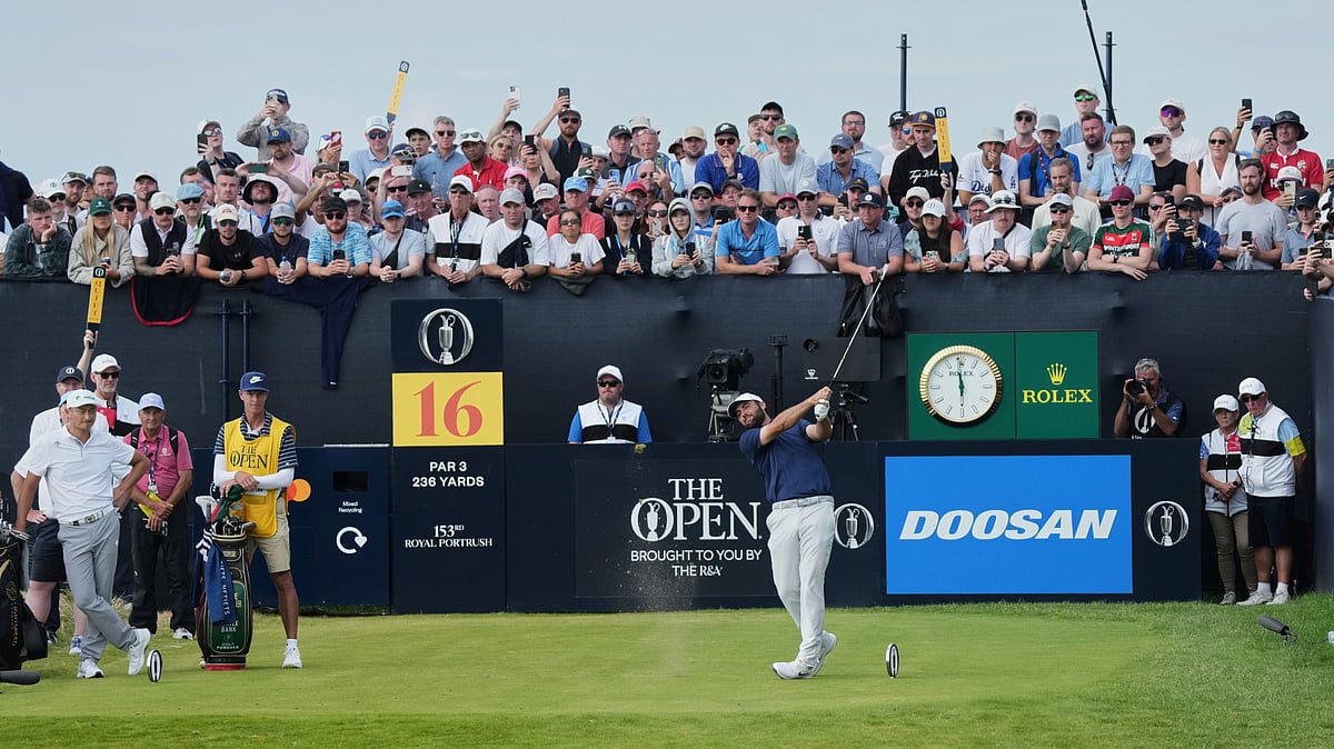 AP Photo/Jon Super : Scottie Scheffler of the United States tees off on the 16th hole during the final round of the British Open golf championship at the Royal Portrush Golf Club.