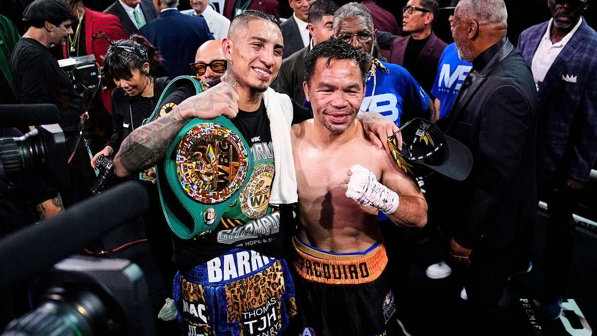 | Photo: AP/John Locher : Mario Barrios, left, and Manny Pacquiao one for a photo after fighting to a majority draw in a welterweight title boxing match Saturday, July 19, 2025, in Las Vegas.