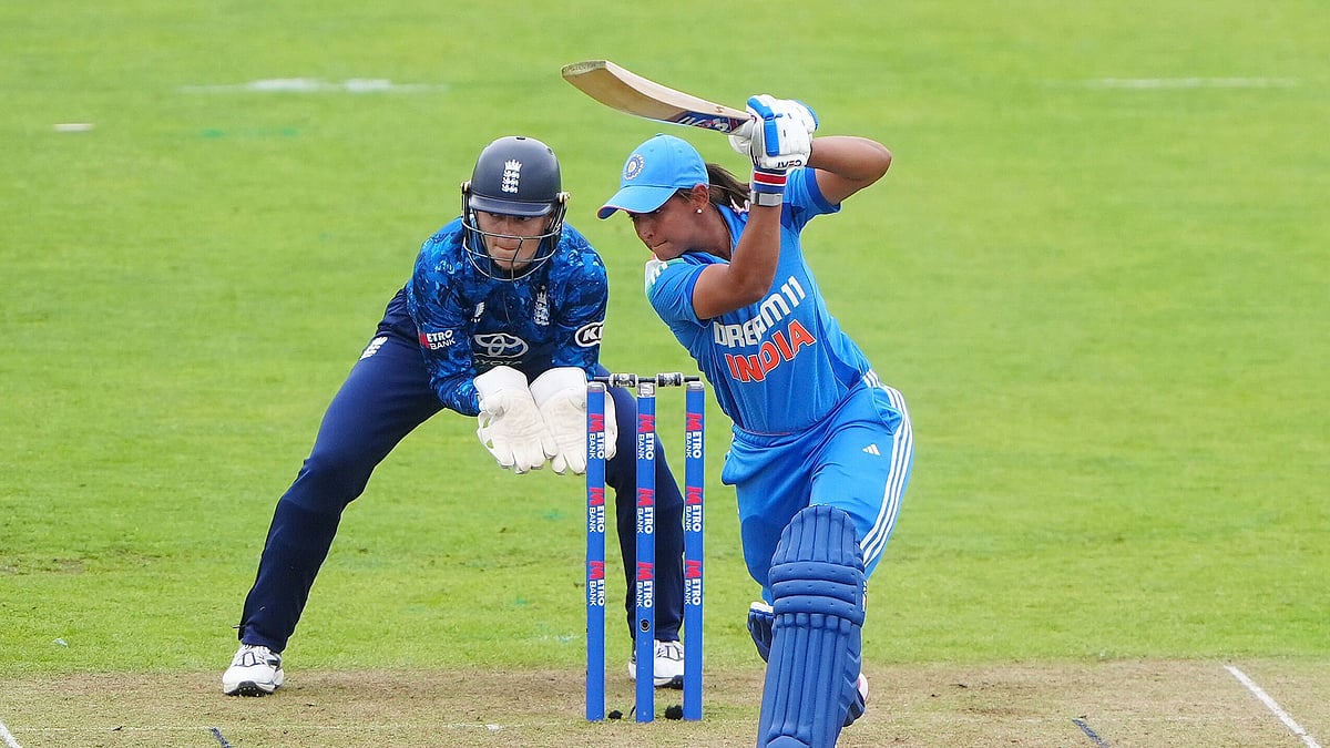 Owen Humphreys/PA via AP : India's Harmanpreet Kaur hits a boundary for four during the third women's one day international match at the Banks Homes Riverside, England.