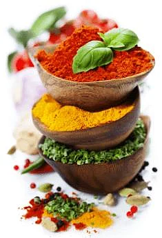 Stacked wooden bowls with colorful spices and herbs