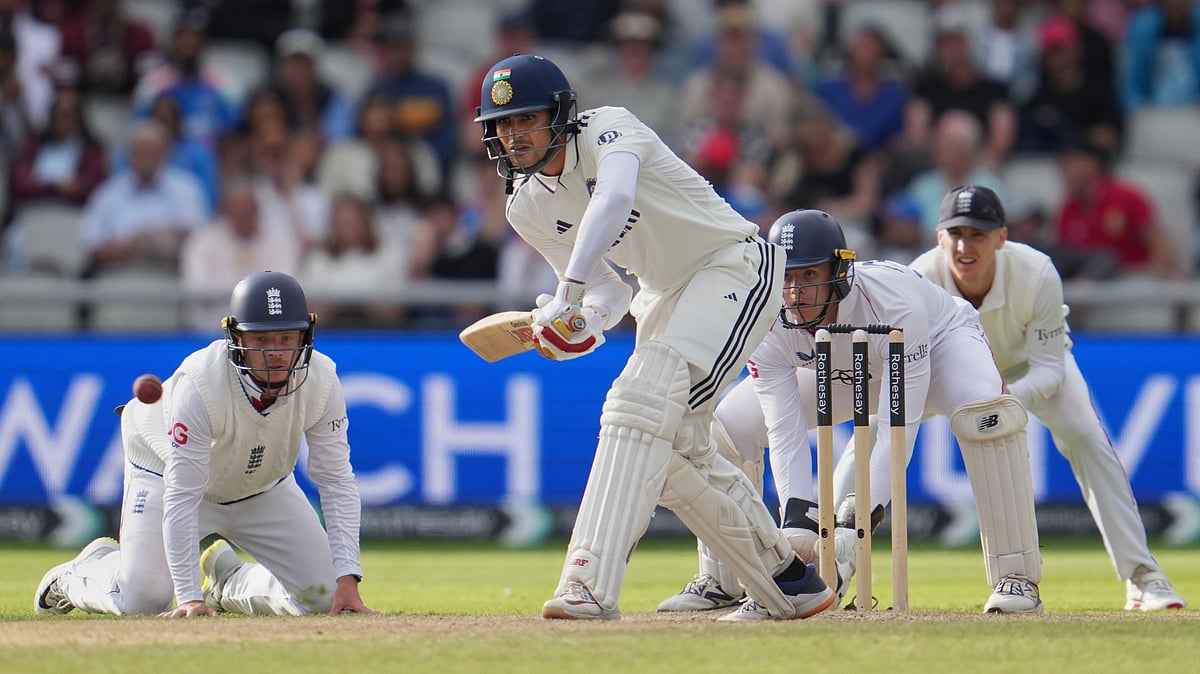 AP Photo/Jon Super : India's captain Shubman Gill plays a shot on the fourth day of the fourth cricket test match between England and India at Emirates Old Trafford, Manchester.