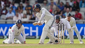 AP Photo/Jon Super : India's captain Shubman Gill plays a shot on the fourth day of the fourth cricket test match between England and India at Emirates Old Trafford, Manchester.