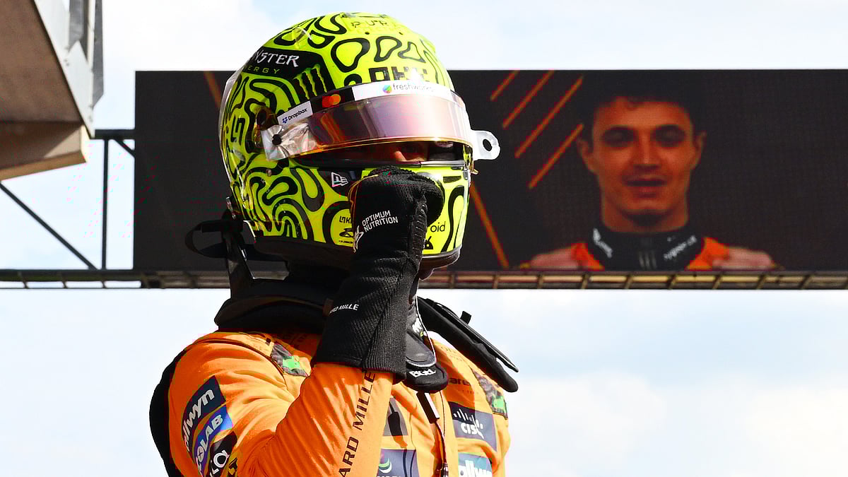 Lando Norris celebrates after topping the timesheets
