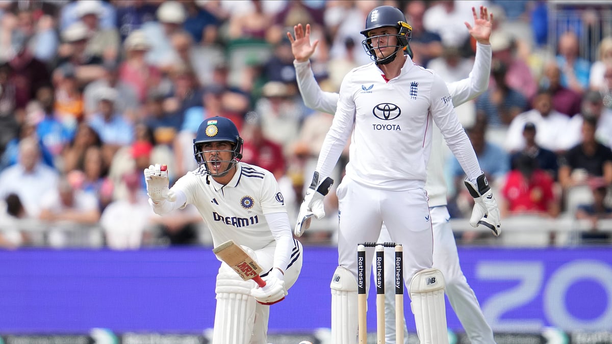 AP Photo/Jon Super : India's captain Shubman Gill stops batting partner KL Rahul on the fourth day of the fourth cricket test match between England and India at Emirates Old Trafford, Manchester.