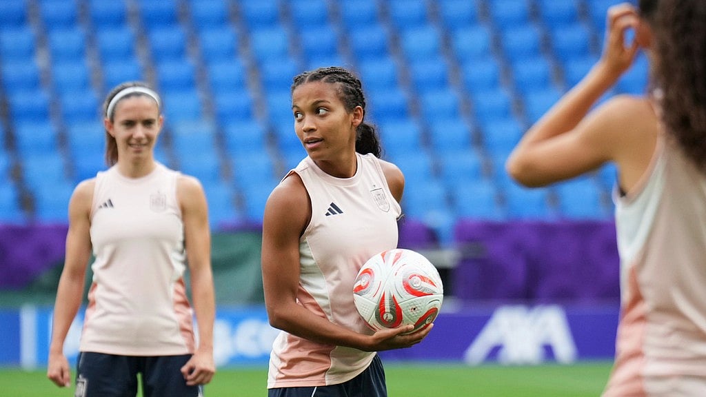 AP : England vs Spain, UEFA Women's Euro 2025: Vicky Lopez holds a ball watched by teammate Aitana Bonmati, in the background, during a training session