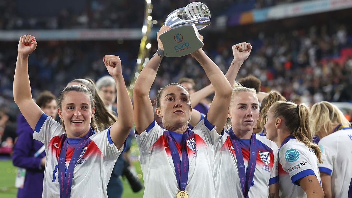 Lucy Bronze lifts the Euros trophy after victory with England