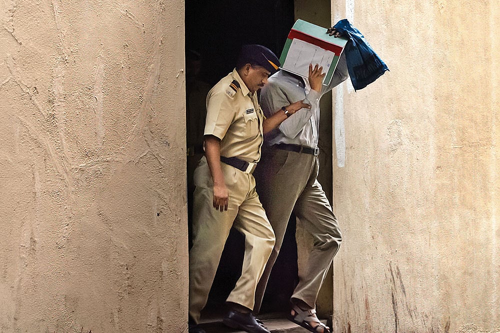 | Photo: Getty Images : During the Trial: A police constable taking a 7/11 blast accused from the Sessions Court after a hearing 