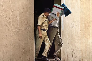 | Photo: Getty Images : During the Trial: A police constable taking a 7/11 blast accused from the Sessions Court after a hearing