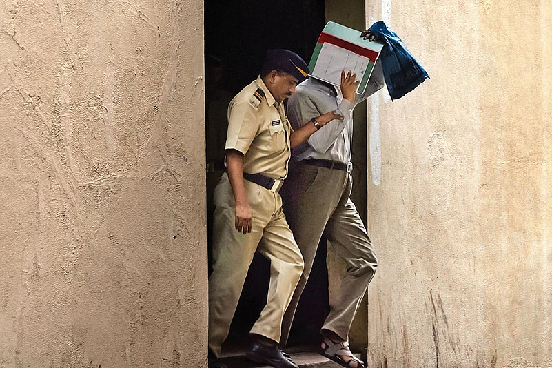 A police constable taking a 7/11 blast accused from the Sessions Court after a hearing