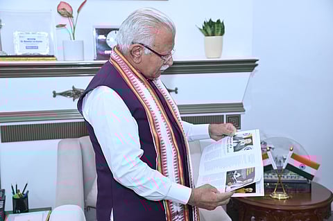 Shri Manohar Lal reading the Outlook Collector’s Edition titled “The Man, The Vision, The Mission”