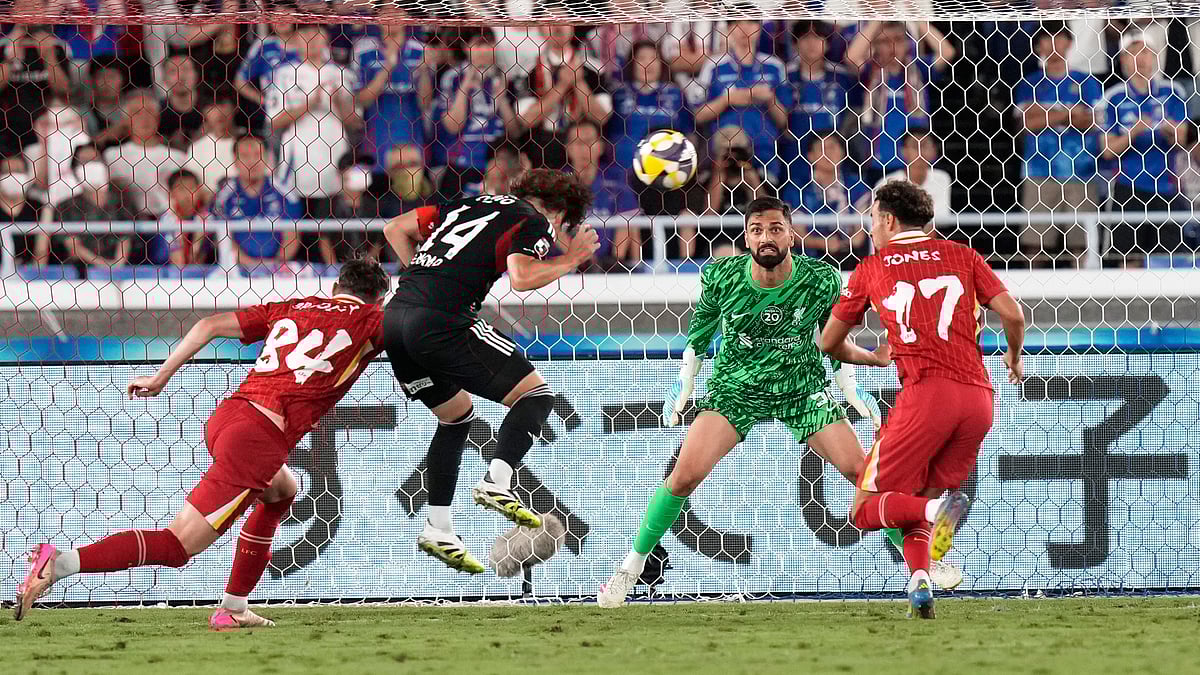 Marinos Asahi Uenaka heads a successful shot at Liverpools goal. AP