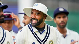 AP/Kirsty Wigglesworth : India's Mohammed Siraj smiles as he leaves for tea with team mates during the second day of the fifth Test