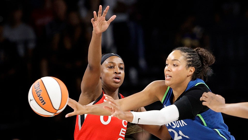 AP : Las Vegas Aces center A'ja Wilson (22) drives against Minnesota Lynx forward Napheesa Collier (24) during the first half of a WNBA basketball game.