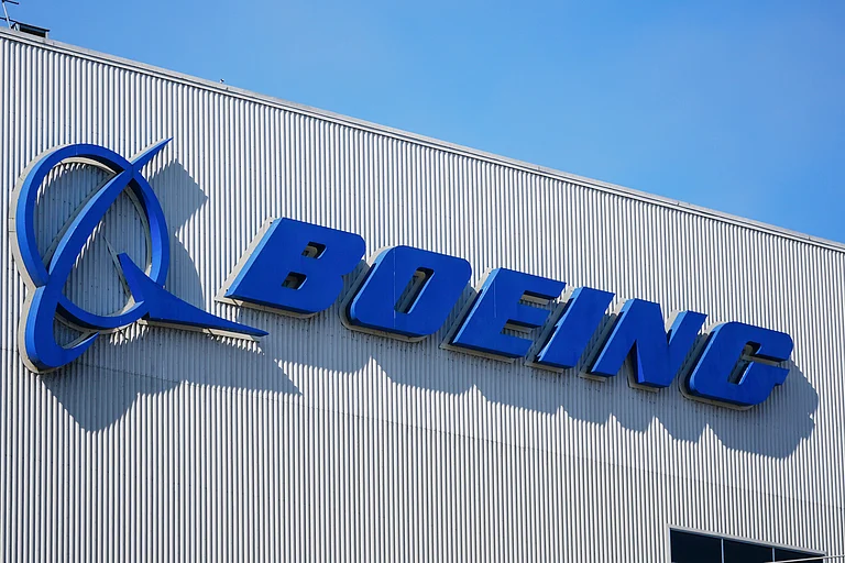The Boeing logo is displayed at the company's factory. - Lindsey Wasson\AP Photo