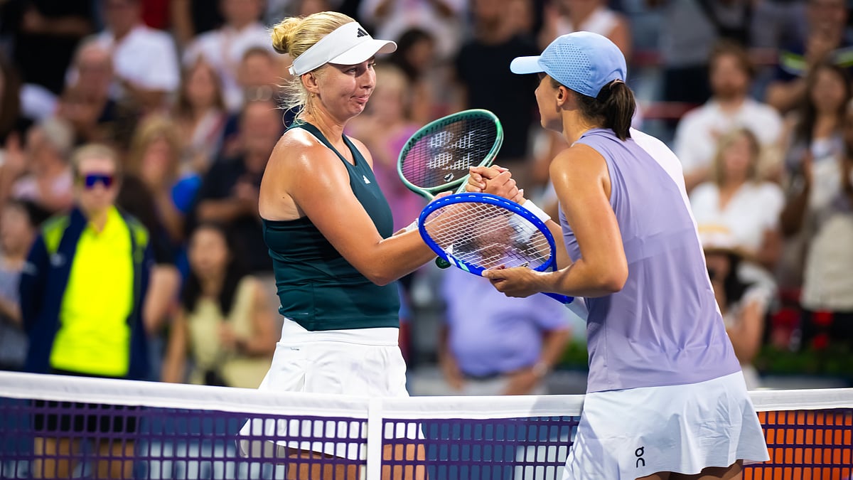 Clara Tauson shakes hands with Iga Swiatek after securing her win in the Canadian Open 2025.