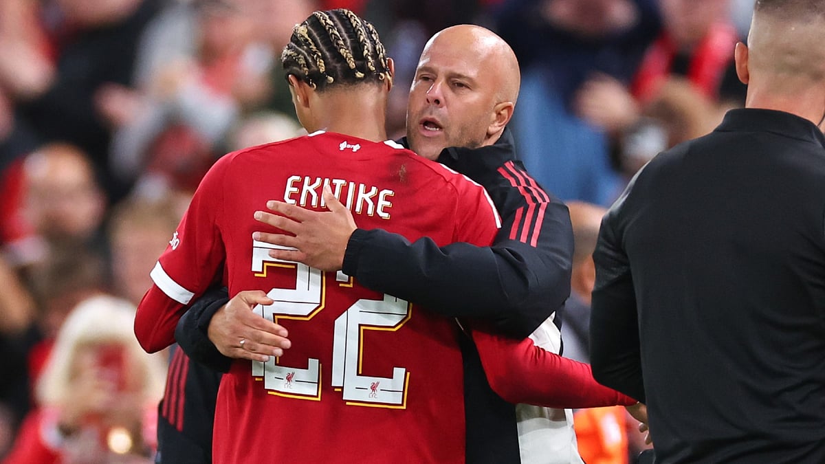 Ekitike and Slot embrace during Liverpool's clash with Bilbao - null