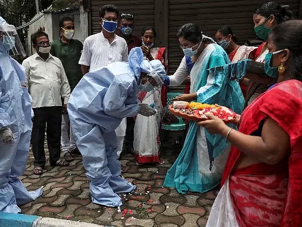 A man taking blessings from a womam