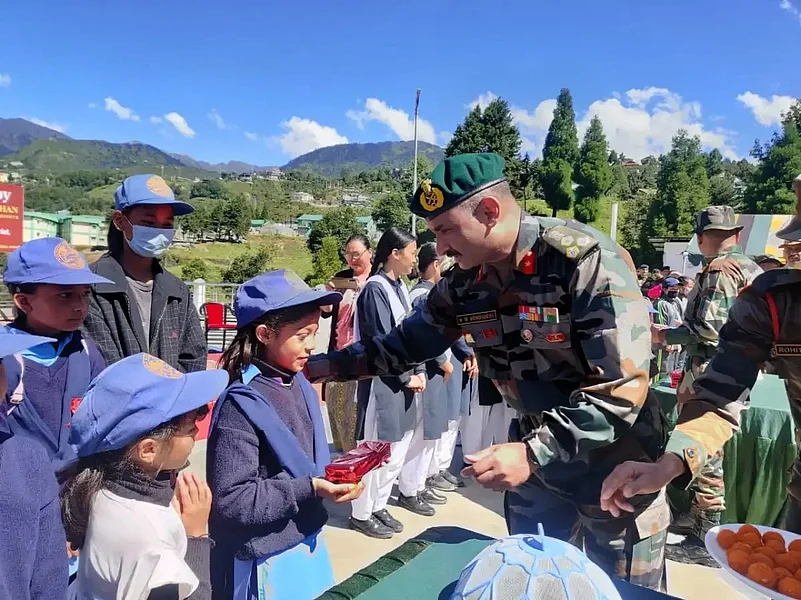 A soldier is giving gifts to the children