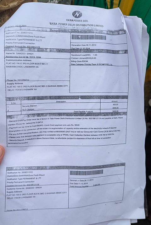 Electricity bill from Bawana shown as proof of installed meters at the flats.