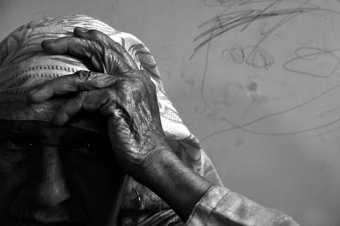 Hajira's only son left home in 1994 for arms training when he was just 17 years old. "He left us all alone, leaving behind a wound in our hearts that won’t heal until the day we die,” she says. Looking at her son's photo she says, that she is still alive and her sons is nowhere. | Yasir Iqbal