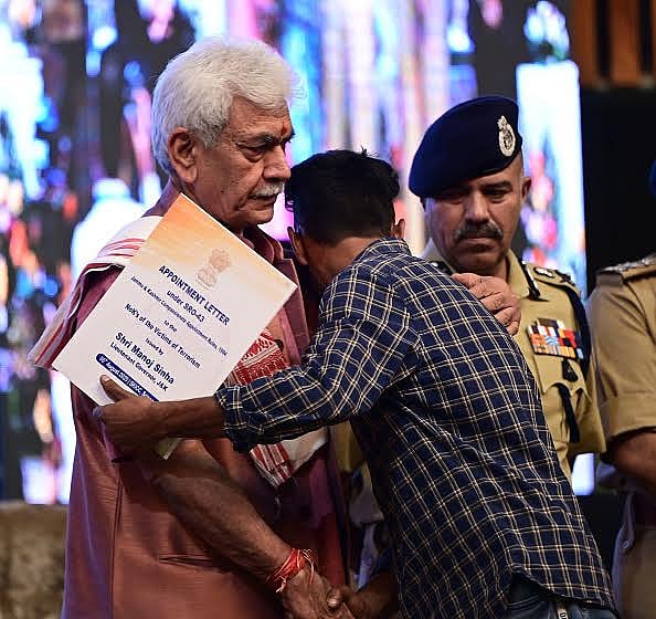 Getty Images : Jammu and Kashmir Lieutenant Governor Manoj Sinha hands over a job appointment letter to family members of terror victims, on August 5, 2025.