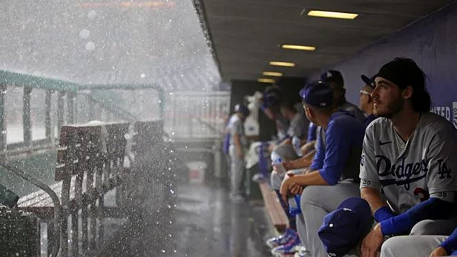 Baseball players sitting in the dugout
