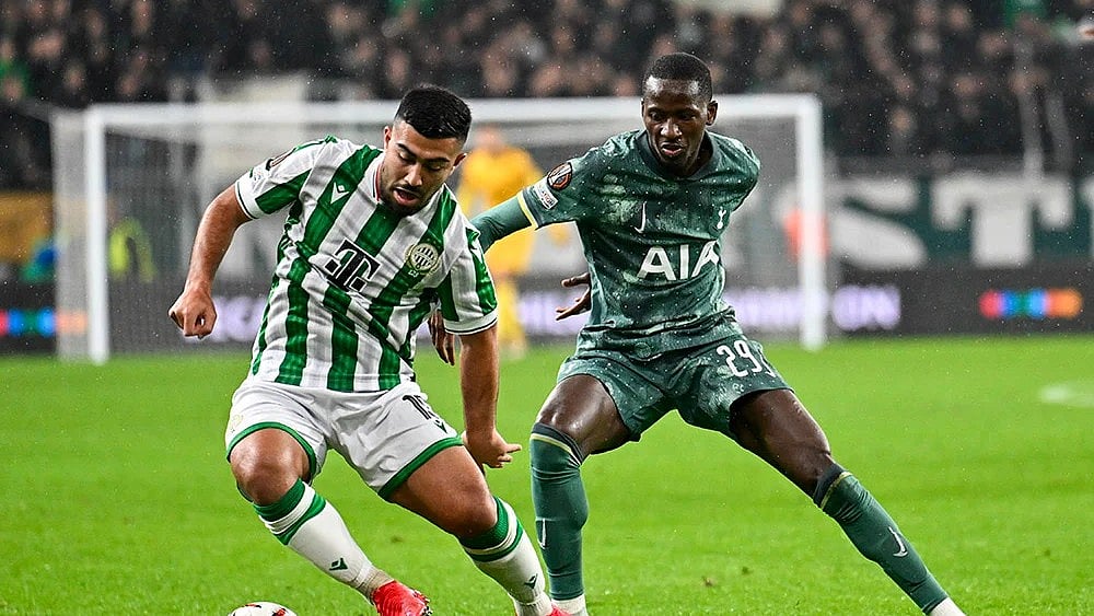 | Photo: AP/Denes Erdos : Ferencvaros' Mohammad Abu Fani, left, is challenged by Tottenham's Pape Matar Sarr.