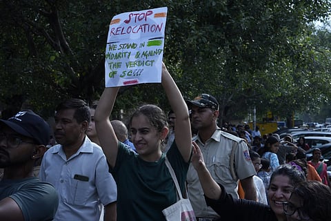 A demonstrator holding up a placard |