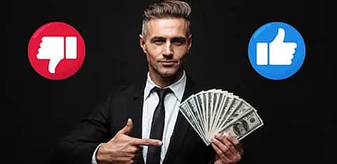 A man wearing a black suit and showing some dollars