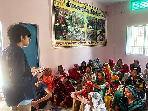 Shivansh Gupta educating a group of women in Haryana
