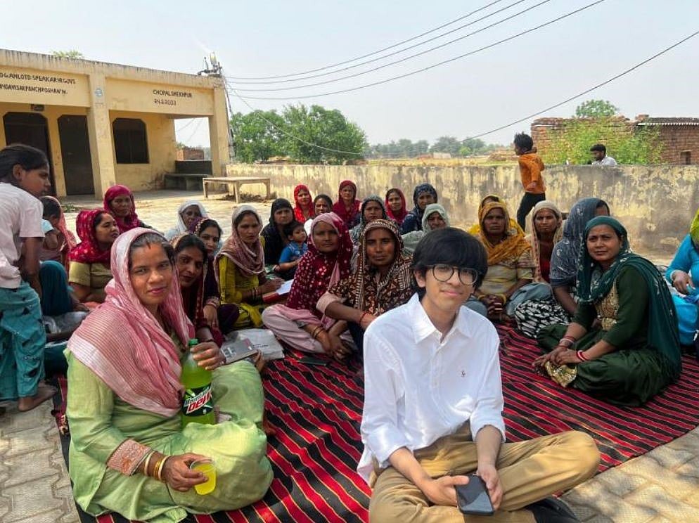 Shivansh Gupta with a group of women in a village