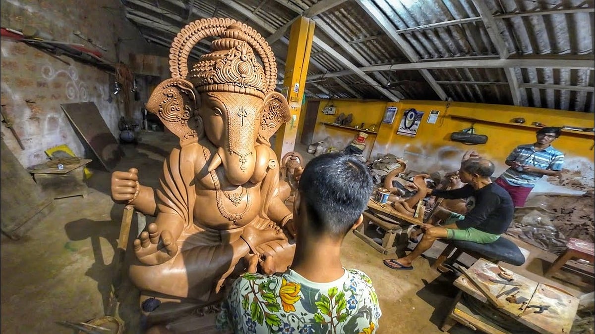 2 men are making Lord Ganesha statue