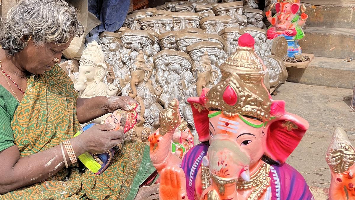 A woman is making statues